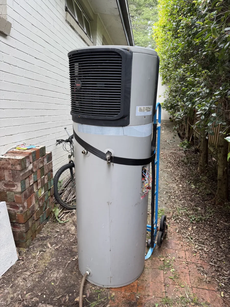 Old Rheem heat pump being removed from Forestville property