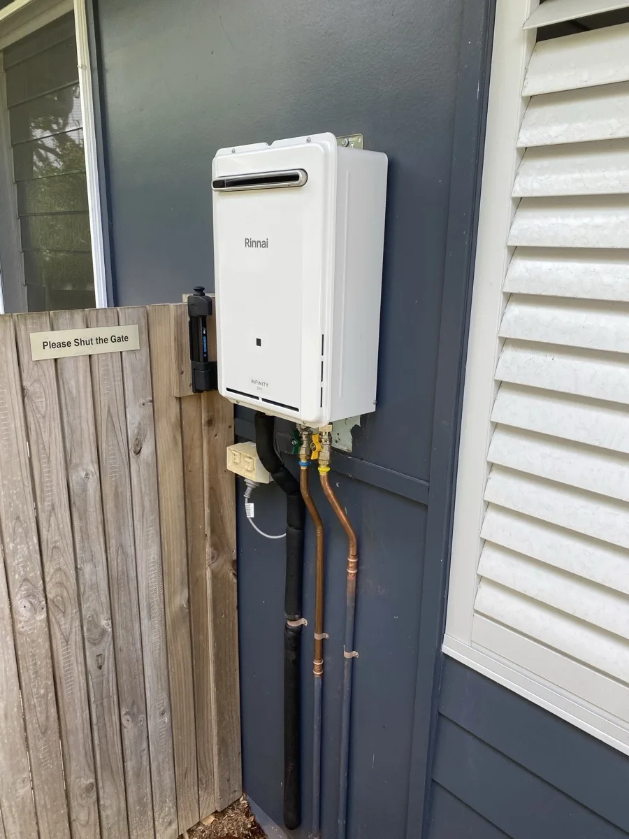 Rinnai Infinity continuous flow gas hot water system mounted on a Manly home exterior wall