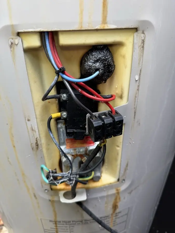 Water-damaged electrical connections inside a Rinnai heat pump hot water system